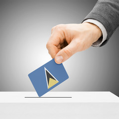 Voting concept - Male inserting flag into ballot box - Saint Luc