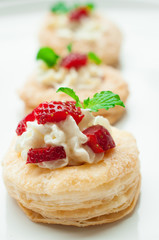 Strawberry Tart with Fresh Cream in Puff Pastry on wooden mat