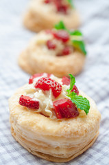 Strawberry Tart with Fresh Cream in Puff Pastry on wooden mat