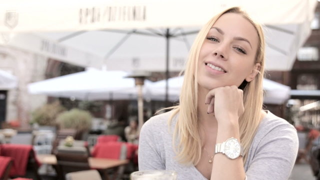 Portrait of beautiful blond woman in cafe. FULL HD.close up