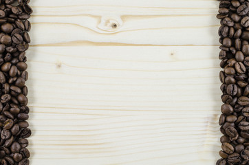 Frame of coffee beans on wooden table. Background