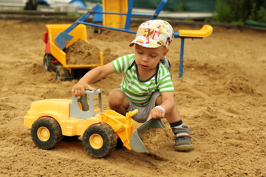 Little boy in the sandbox.