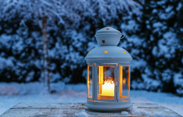 Lantern in garden, winter evening