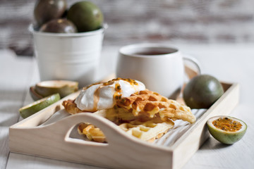 Waffles with cream and passionfruit