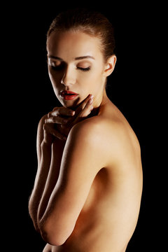 Sensual portrait of nude woman on dark background