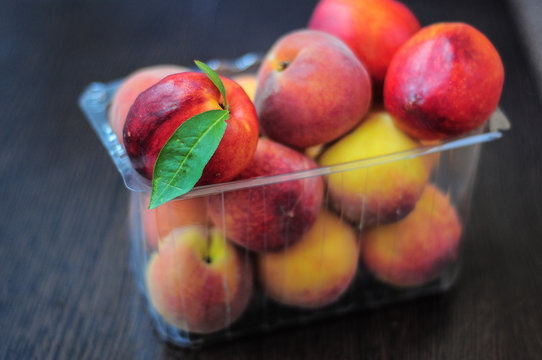 Peaches and nectarines in plastic box