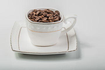an image of a cup filled with coffee beans..