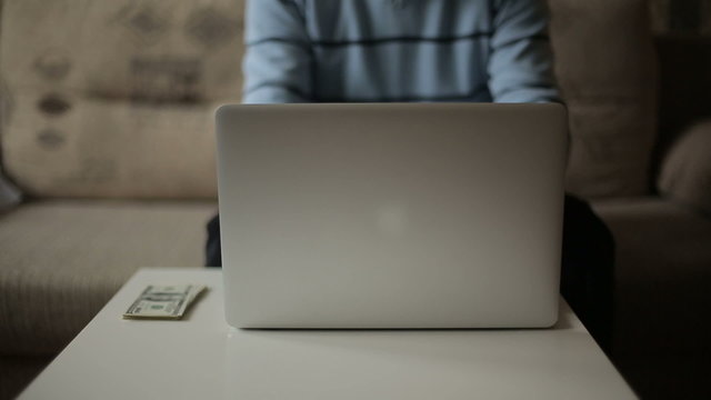 A man working at the computer and make money. Freelancer