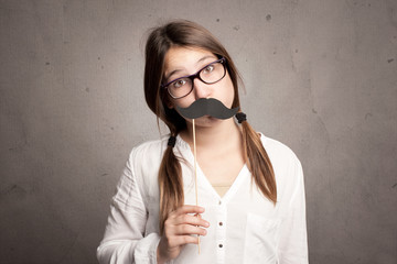 young girl holding a moustache