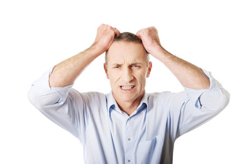 Frustrated man pulling his hair