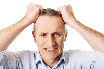 Obraz premium Frustrated man pulling his hair