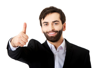 Happy businessman with thumbs up gesture.