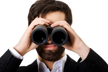 Young businessman with binoculars.