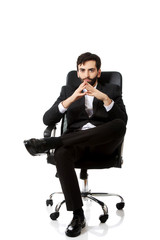 Young businessman sitting on a chair.
