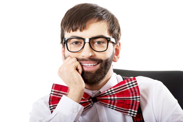 Young old fashioned man sitting by a desk.