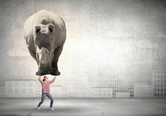 Girl lifting rhino