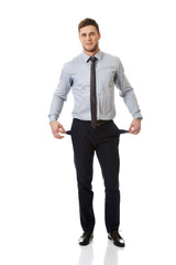 Businessman showing his empty pockets.