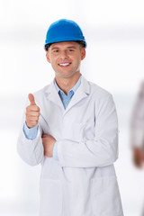 Man in a lab coat and helmet