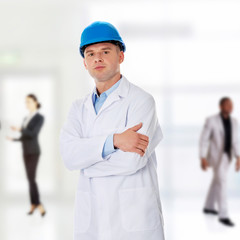 Man in a lab coat and helmet