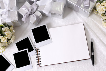 Wedding gifts white lace background with photo album and polaroid style picture frame