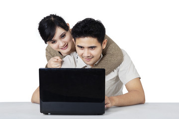 Lovers with laptop isolated over white