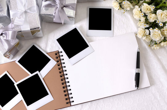 Wedding gifts white lace background with photo album and polaroid style picture frame