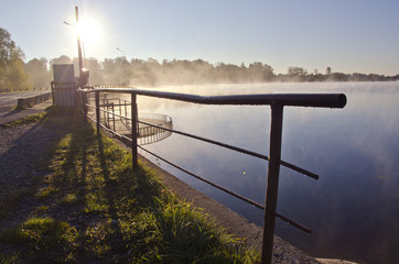 beautiful morning lake landsacpe with fence and fog
