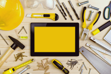 Digital Tablet and Assorted Carpentry Tools  on Workshop Table
