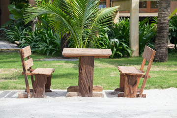 Empty wooden table and chairs of a beach garden near the sea