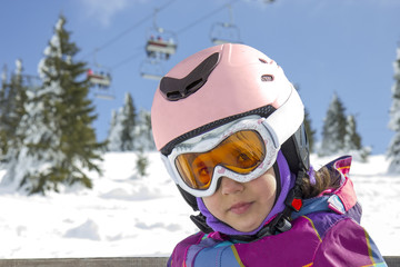 Girl with ski goggles and helmet