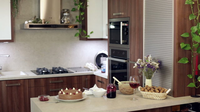Woman making cake at modern kitchen