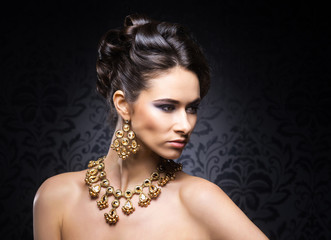 Young, beautiful and rich woman in jewels and makeup