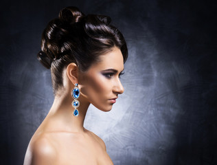Young, beautiful and rich woman in jewels and makeup