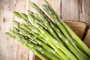 Fototapeta premium Asparagus on the wooden background.