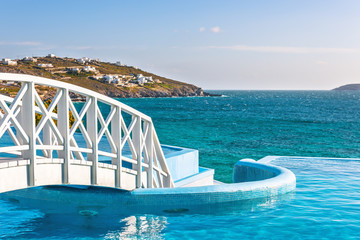 Wooden footbridge over luxury swimming pool
