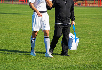 Medic takes care of the injured soccer player © majorosl66