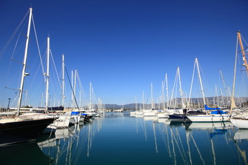 Fototapeta na wymiar Yachts and sail boats reflected in a Marina