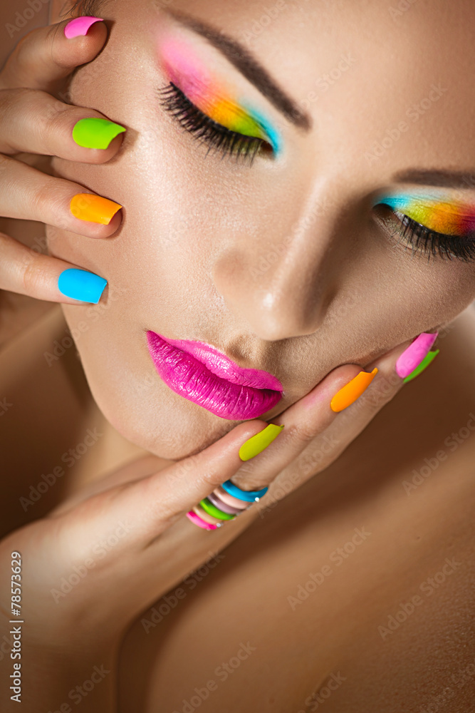 Wall mural Sexy girl portrait with vivid makeup and colorful nailpolish