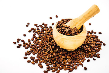 Coffee beans in wooden bamboo mortar isolated on white