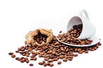 white cup with coffee beans isolated