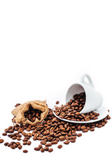 white cup with coffee beans isolated