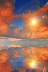 Rainbow at sunset reflected in the calm water