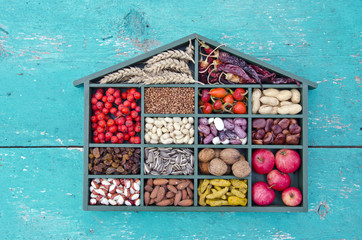 healthy fruits, seeds and dried food ingredient in wooden box