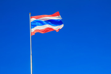 Thai flag of Thailand with blue sky background.