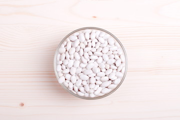 Fototapeta na wymiar raw white beans on the board dietetic food