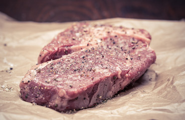 fresh, grilled beef steak on wooden background 