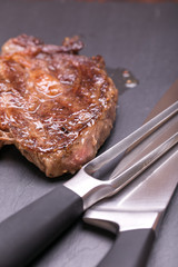 fresh, grilled beef steak on wooden background 