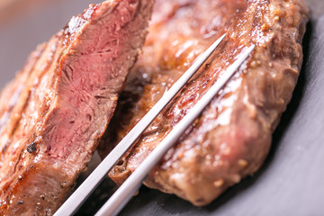 fresh, grilled beef steak on wooden background 