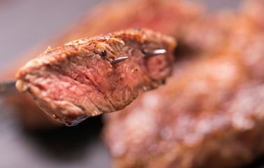 fresh, grilled beef steak on wooden background 