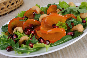 Salad greens with persimmon, pomegranate and cashews